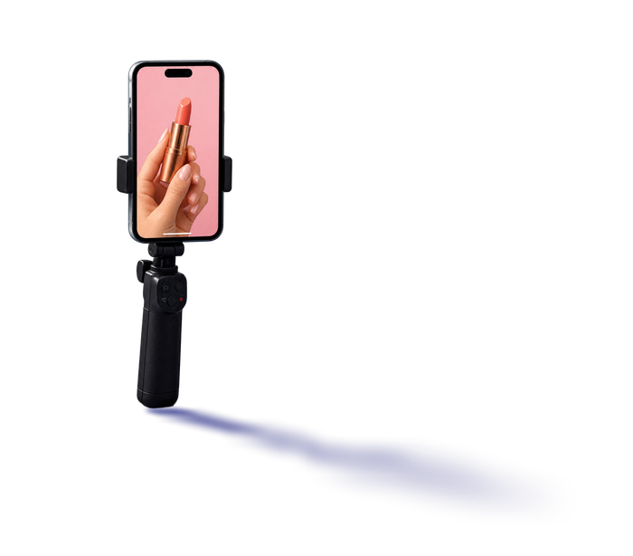 Phone held upright on a black handheld grip, screen lit