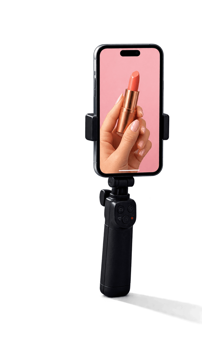 Phone held upright on a black handheld grip, screen lit